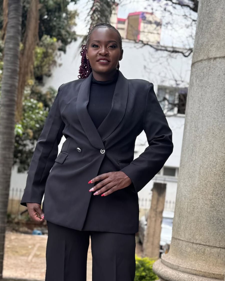 Model in a black tailored suit outdoors